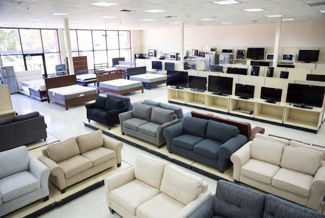 Affordable rent-to-own furniture showroom with sofas, mattresses, and appliances