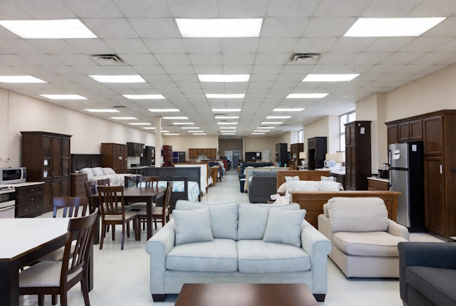 Local no-credit-check furniture showroom with sofas, appliances, and bedroom sets