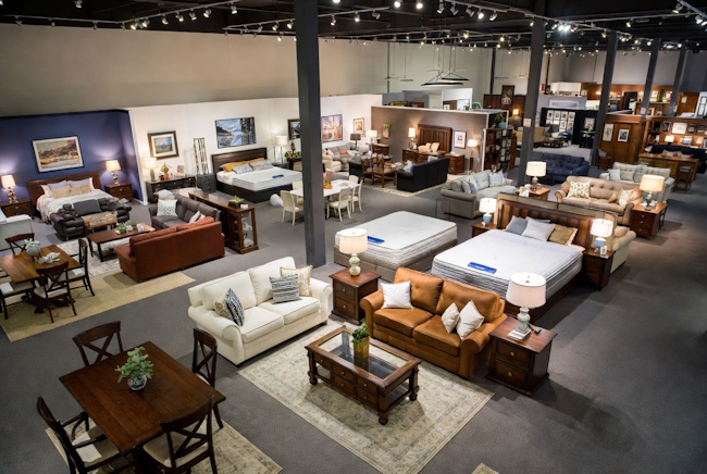 Local furniture showroom with mattresses, living room sets, dining furniture, and leasing options
