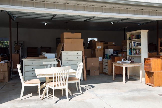 Used furniture prepared for local pickup with a dining table, chairs, dresser, and boxes