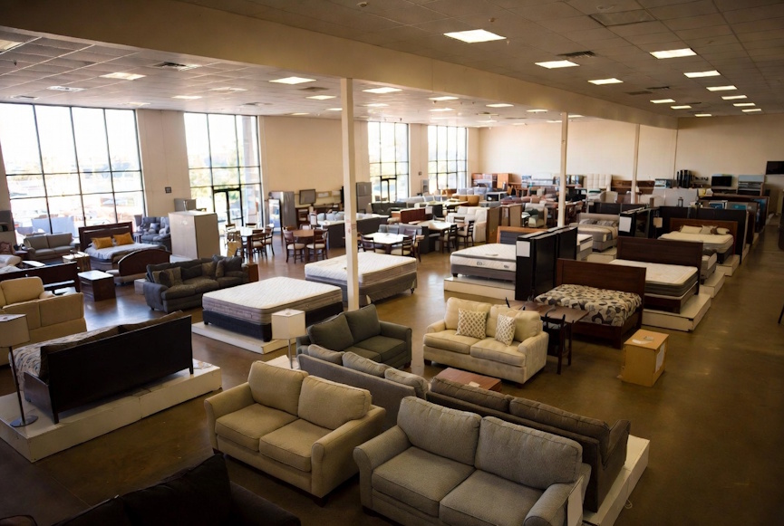 Rent-to-own furniture showroom with sofas, bedroom sets, and dining furniture in Baton Rouge