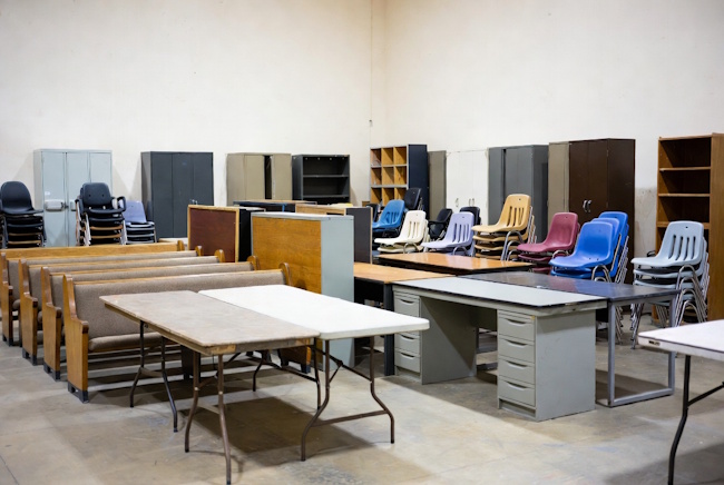 Used church furniture with pews, folding tables, stackable chairs, and office furniture