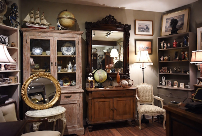 Vintage furniture and home décor shop with artwork, mirrors, accent tables, and collectibles