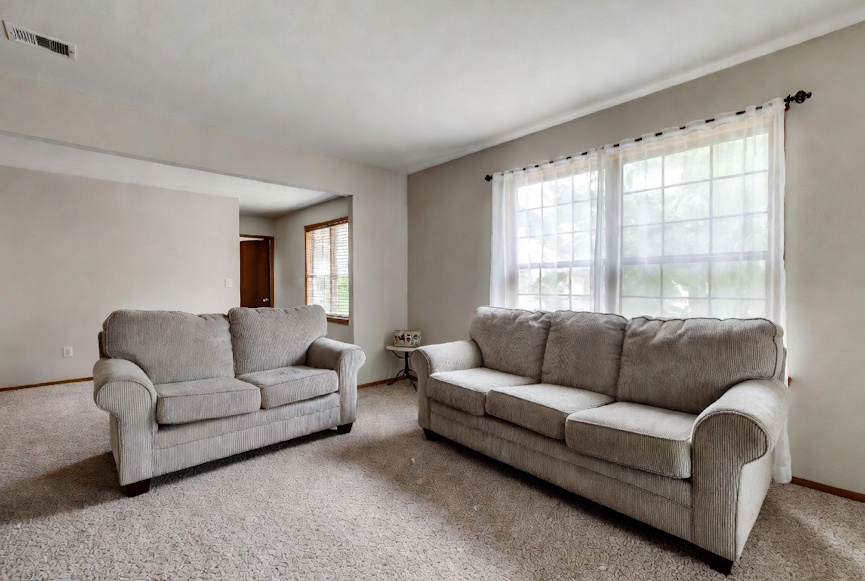 Well-maintained sofa and loveseat in a bright Baton Rouge living room